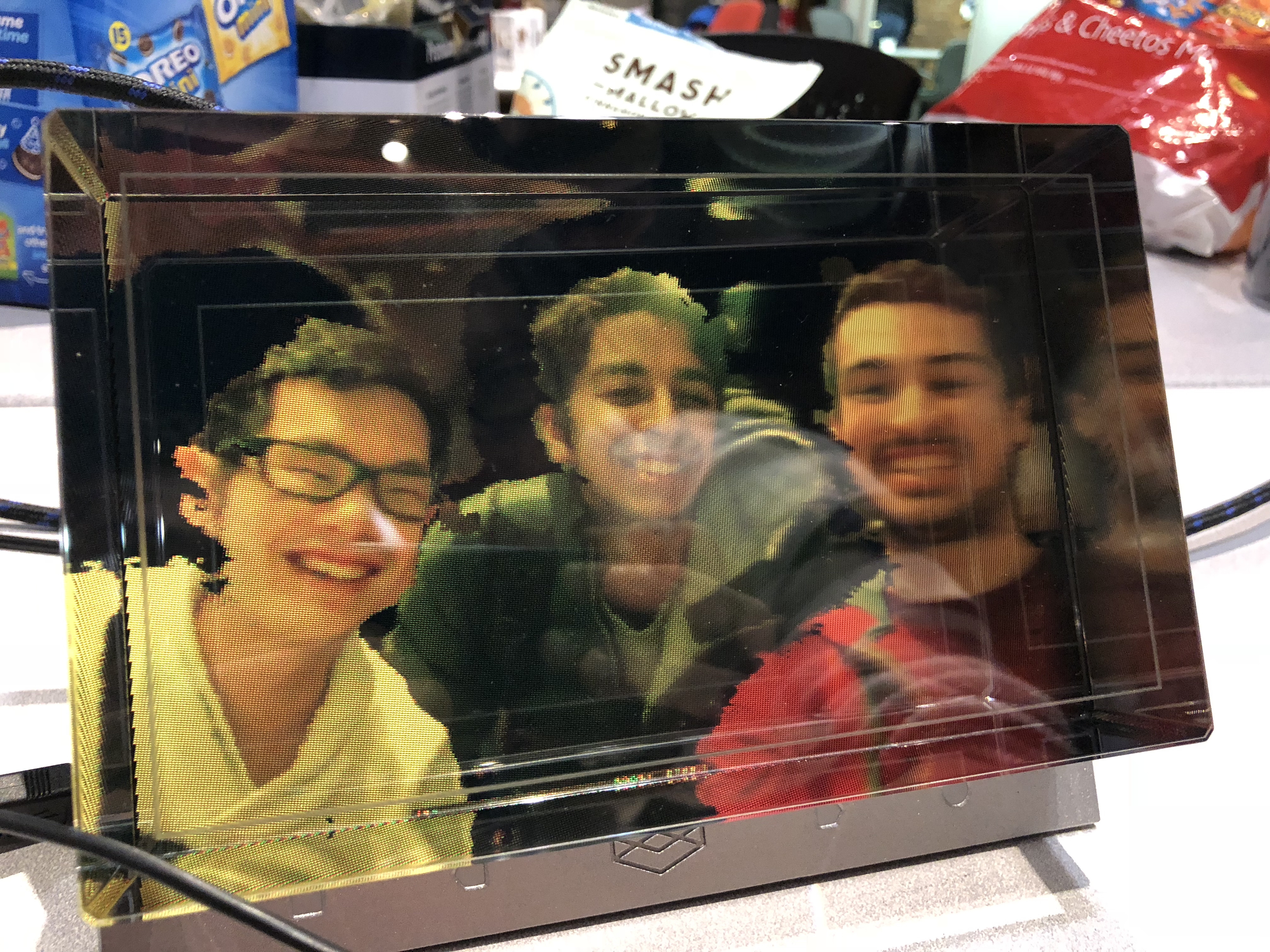 Photo of a holographic display with Phillip, Cyrus and Kumail in it
